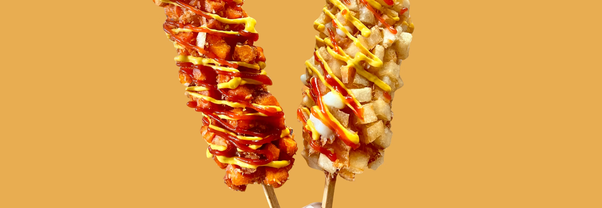 Close-up of Korean corndogs with sauces